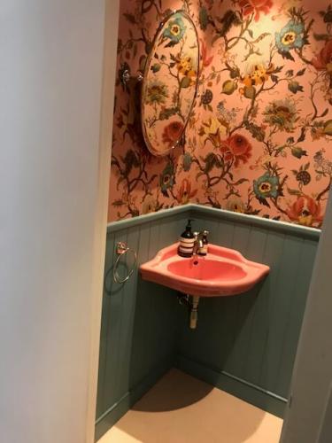 Vintage-style bathroom with vibrant floral wallpaper